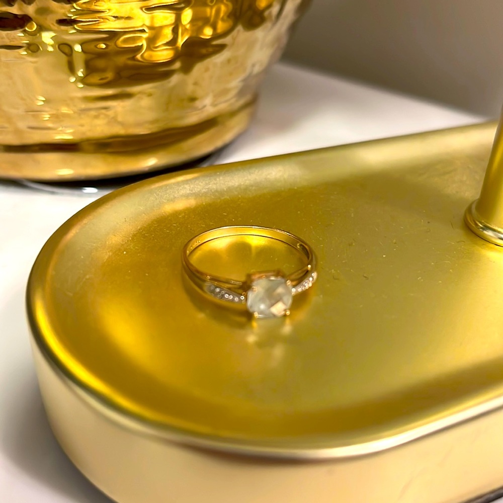 Gold ring with light blue gemstone